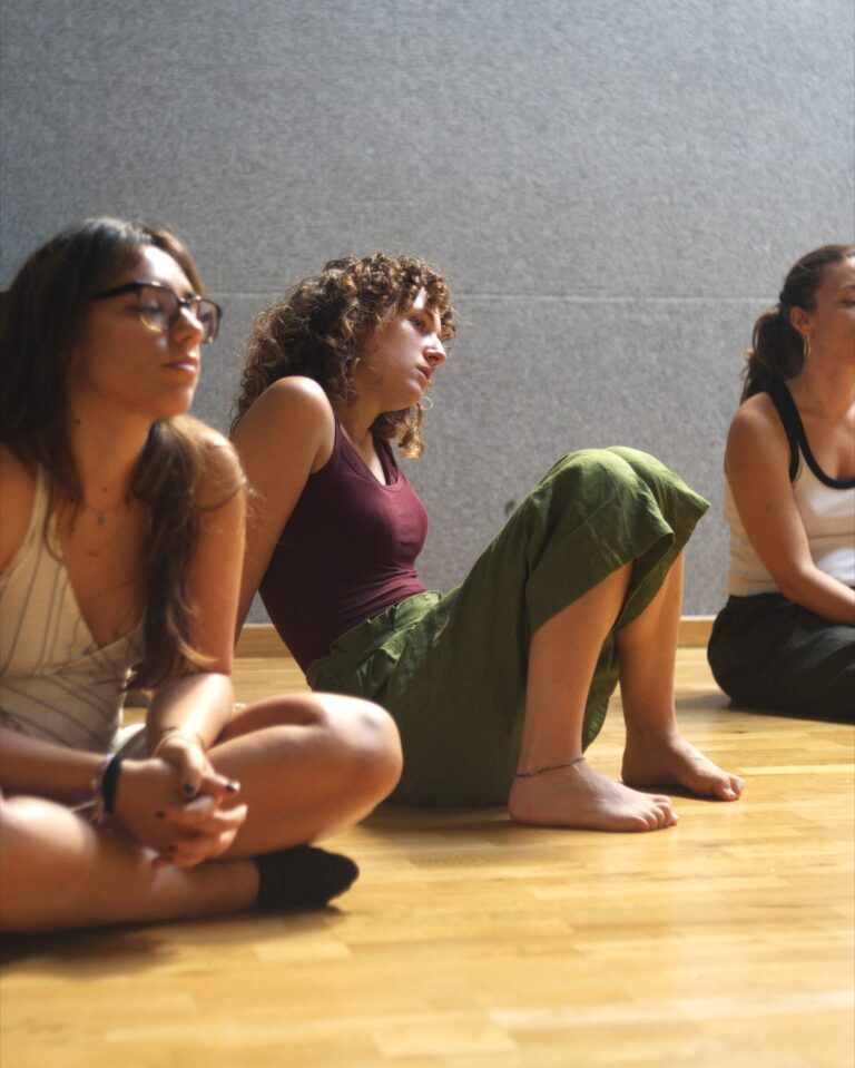Students sitting on the floor listening during the DRAMA Open Day