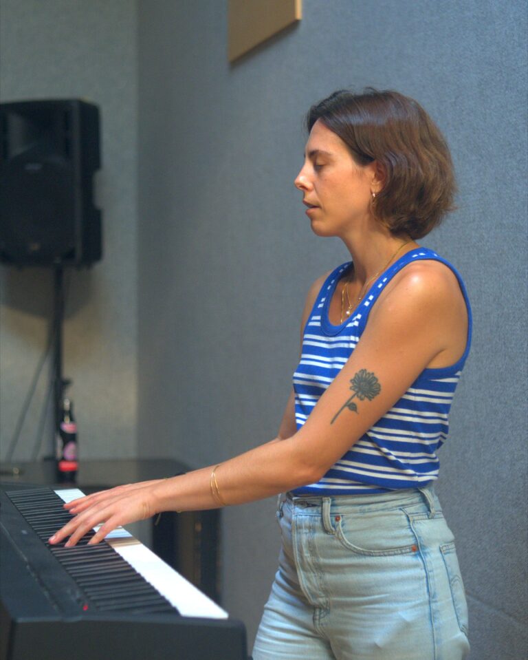 A teacher plays the keyboard in the studio during the DRAMA Open Day