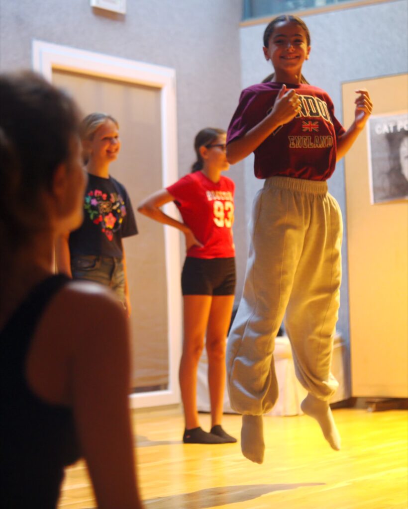 A No Drama student jumping during an exercise in the studio