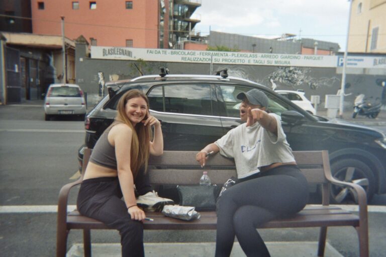 Students sitting on the bench outside Mob Studios