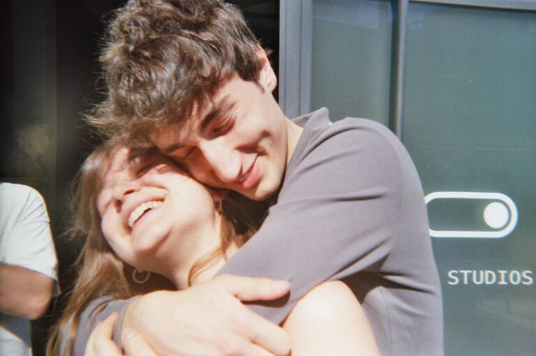 A hug in front of the Mob Studios sign