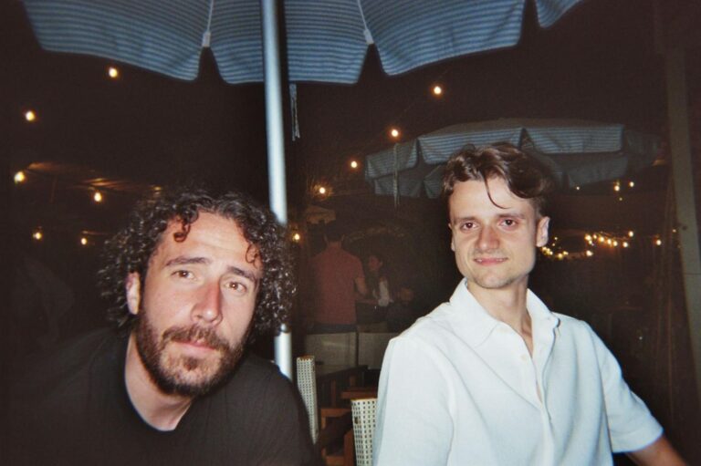 The trainer and a student sitting at dinner, in the evening