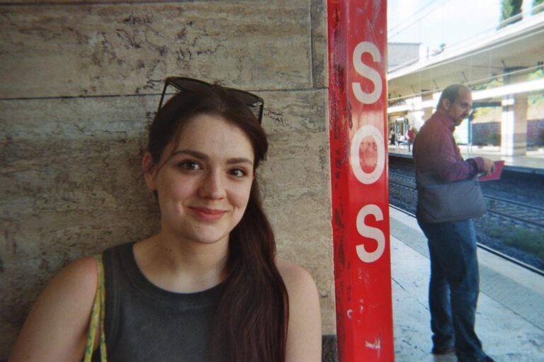 Portrait of a student at the station, next to the SOS pole