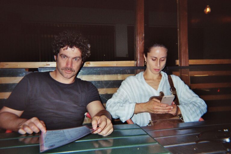 The trainer and a student sitting at the table in the evening