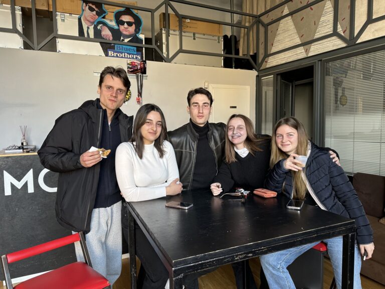 Five students at the high table in the Mob Studios entrance