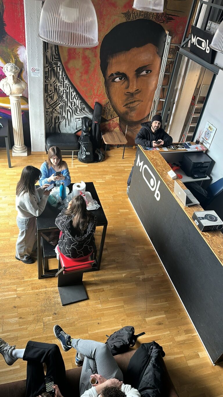 The Mob Studios entrance seen from above, with the mural, the counter and the students