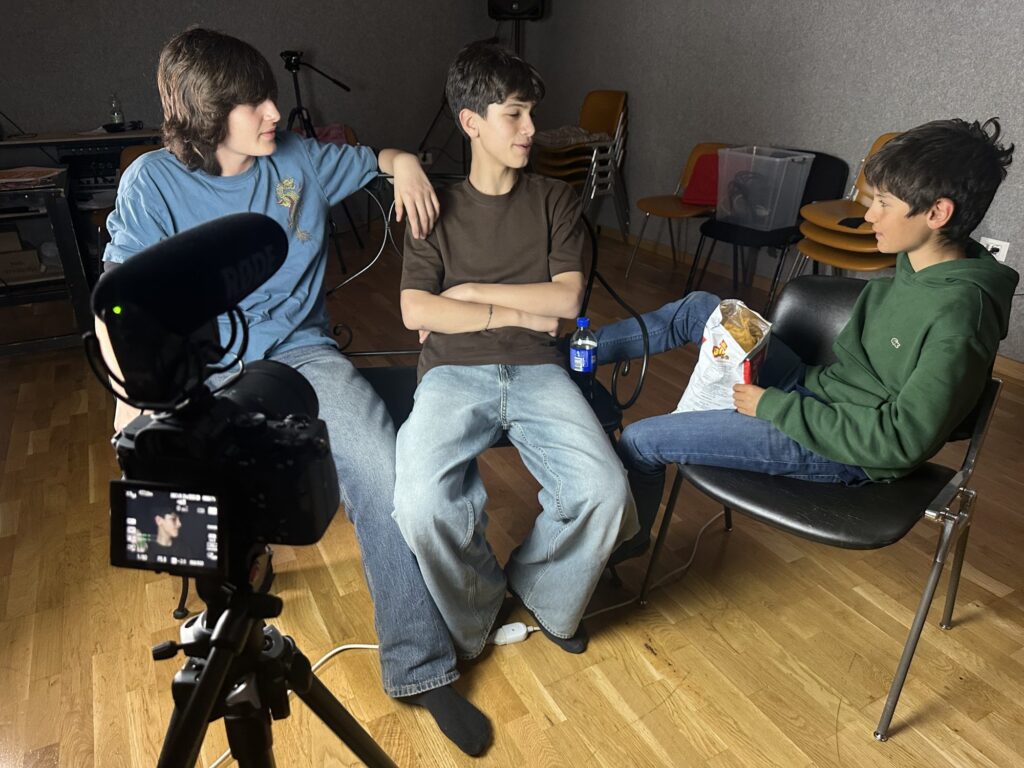 No Drama students sitting in front of the camera during a shoot