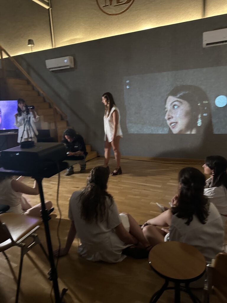 Persona: la sala con il proiettore, il pubblico seduto a terra