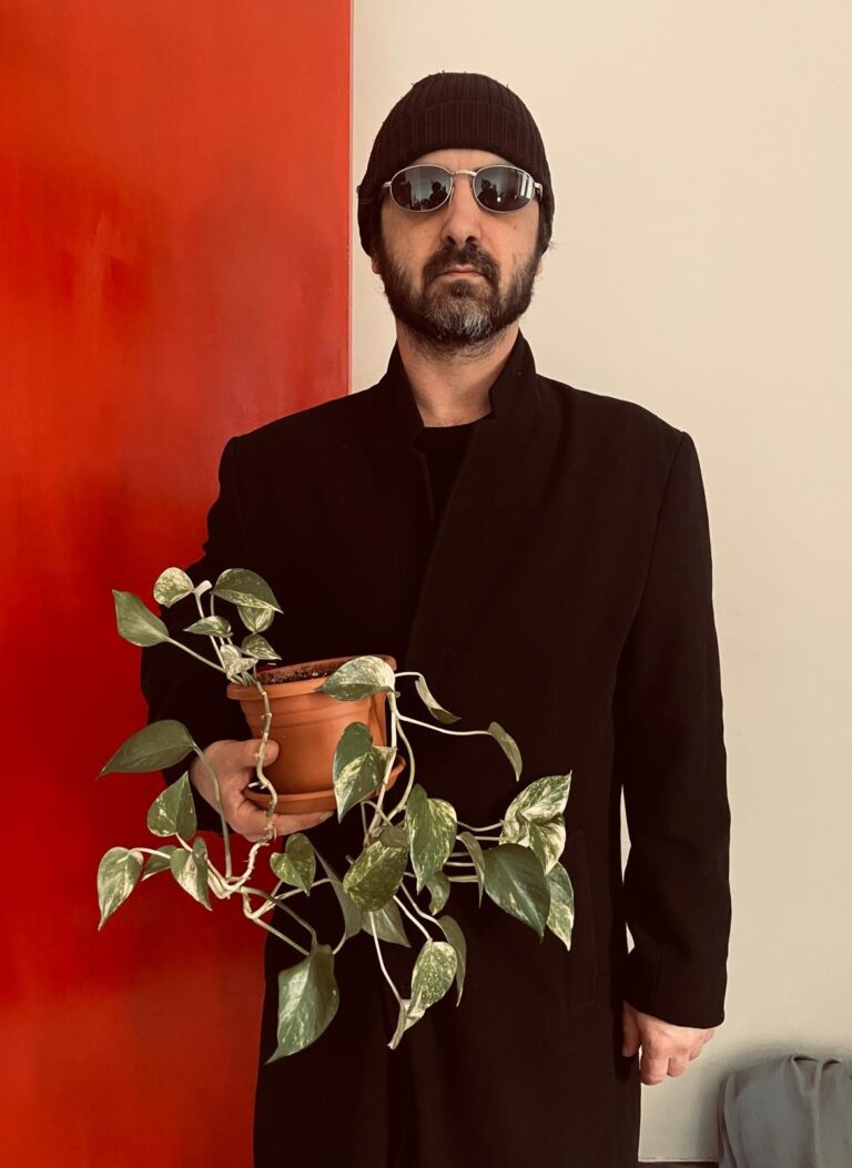 Portrait holding a plant, on a red and white background