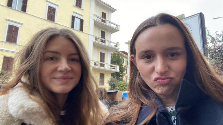 A selfie of two students on the street