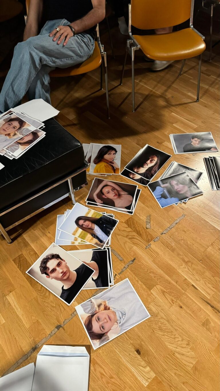 Prints of photo books scattered on the studio floor