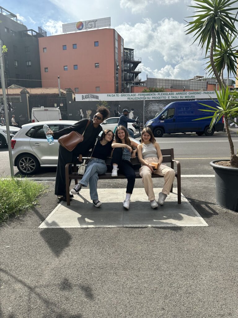 A group of students posing on the bench outside Mob Studios