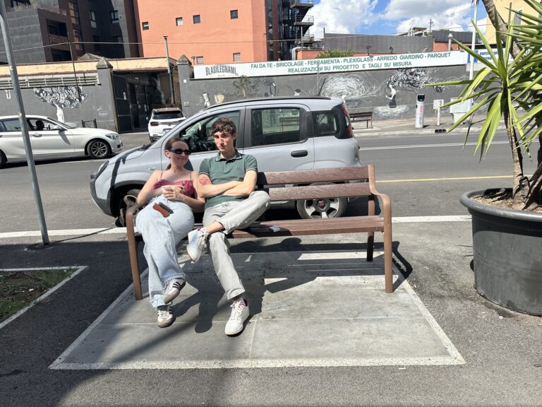 Two boys sitting on the bench outside Mob Studios