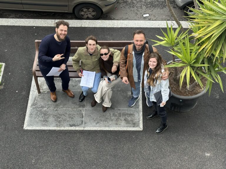Students and teachers posing on the bench, seen from above