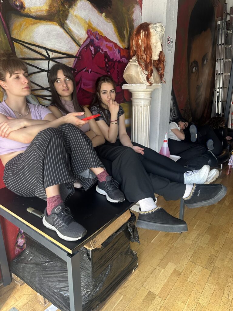 A rest on the sofa in front of the mural during the shooting of Triopatia